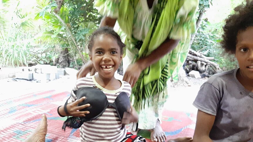 Child playing with a bra  in remote island of Futuna Vanuatu