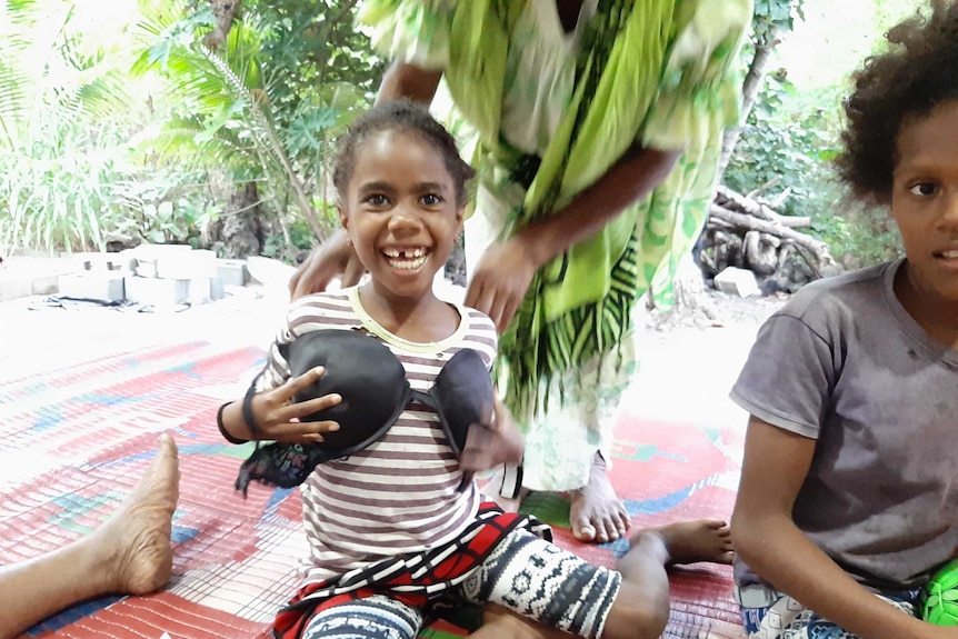 Child playing with a bra  in remote island of Futuna Vanuatu