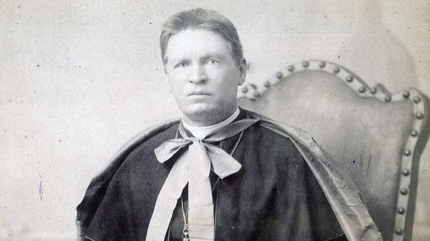 An old black and white photo of Bishop William Bernard Kelly sitting in a chair.