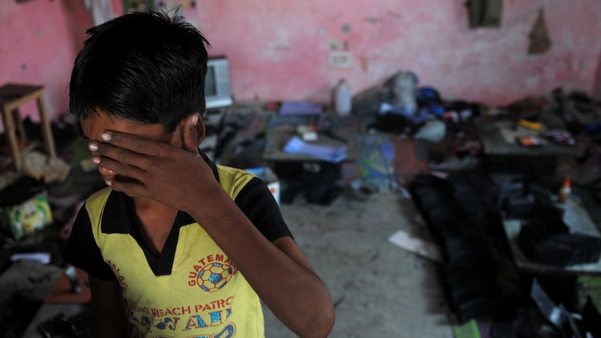 An Indian bonded child labourer crying during a raid.