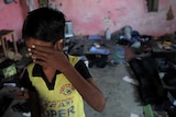 An Indian bonded child labourer crying during a raid.