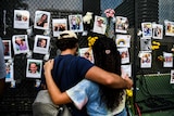 People visit the makeshift memorial for the victims of the building collapse