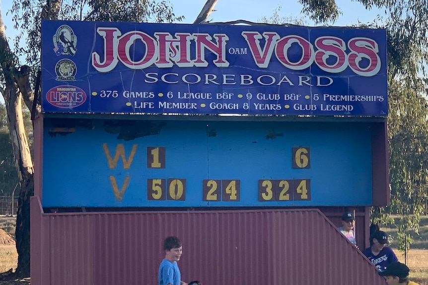 A country football ground scoreboard showing 6 points for the home team and 324 points for the away.