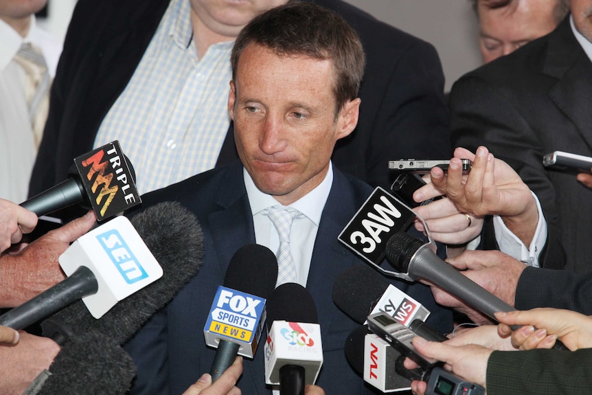 Damien Oliver speaks to media outside Racing Victoria HQ after being banned.