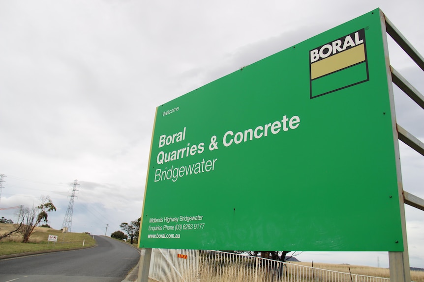 A green sign with the words Boral Quarries and Concrete