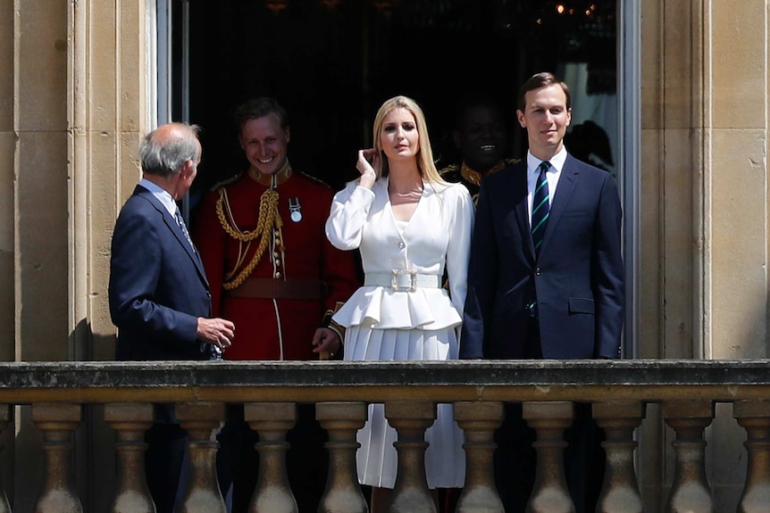 Jared Kushner and Ivanka Trump watch from a window.