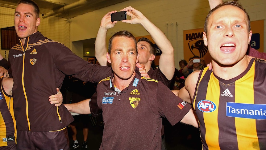 Coach Alastair Clarkson (C) with Hawks Max Bailey (L) and Brad Sewell after win over Geelong.