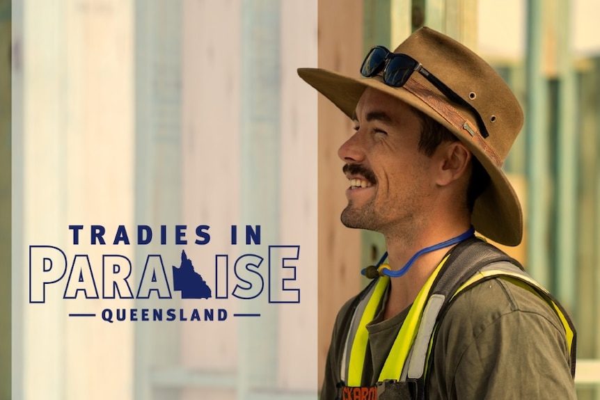 A man wearing hi-vis and smiling with words Tradies in Paradise Queensland