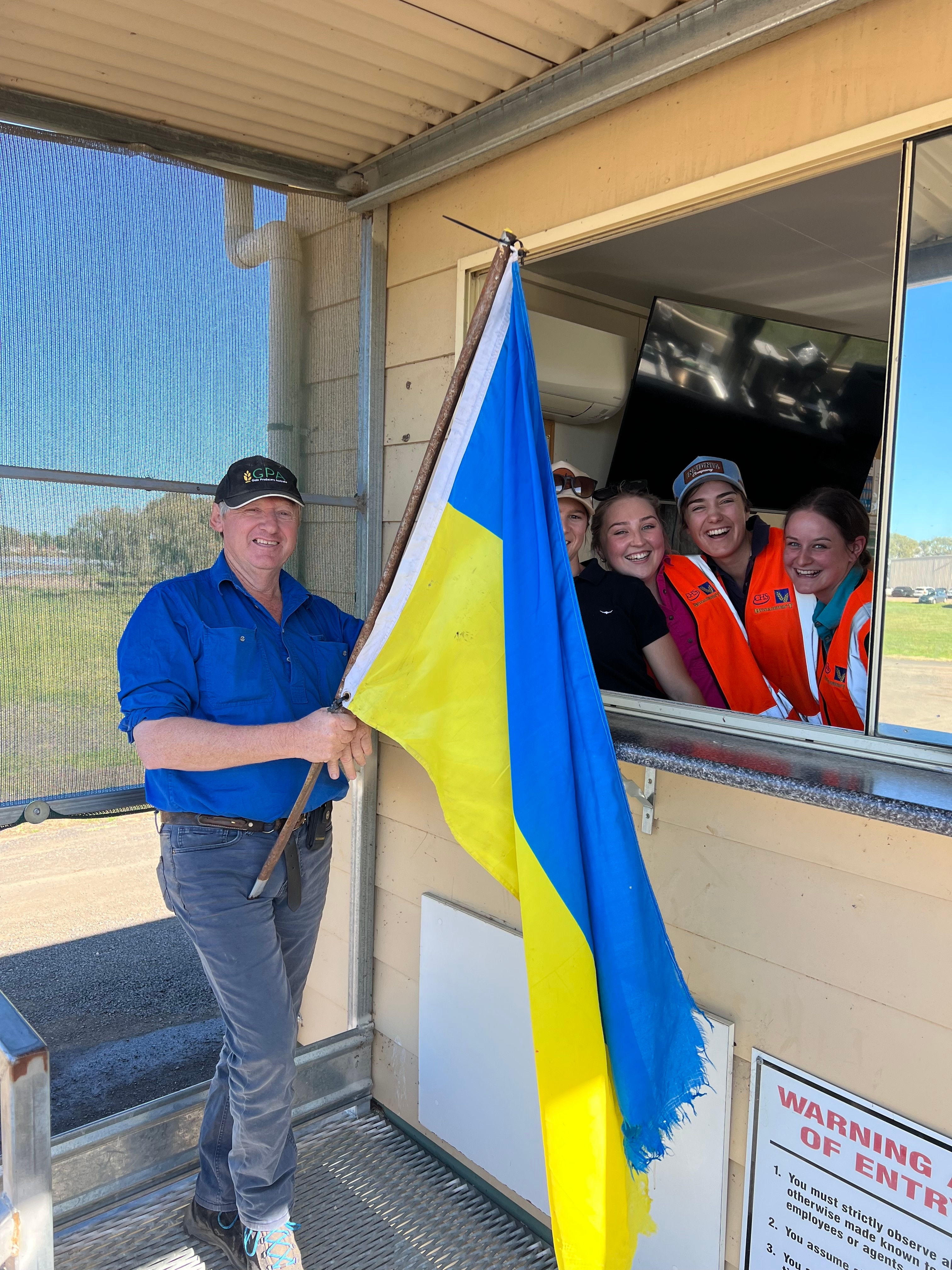 Farmer standing with the Ukraine flag