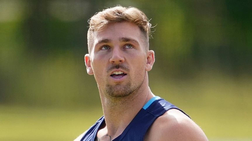 Bryce Cartwright looks up wearing a dark blue singlet