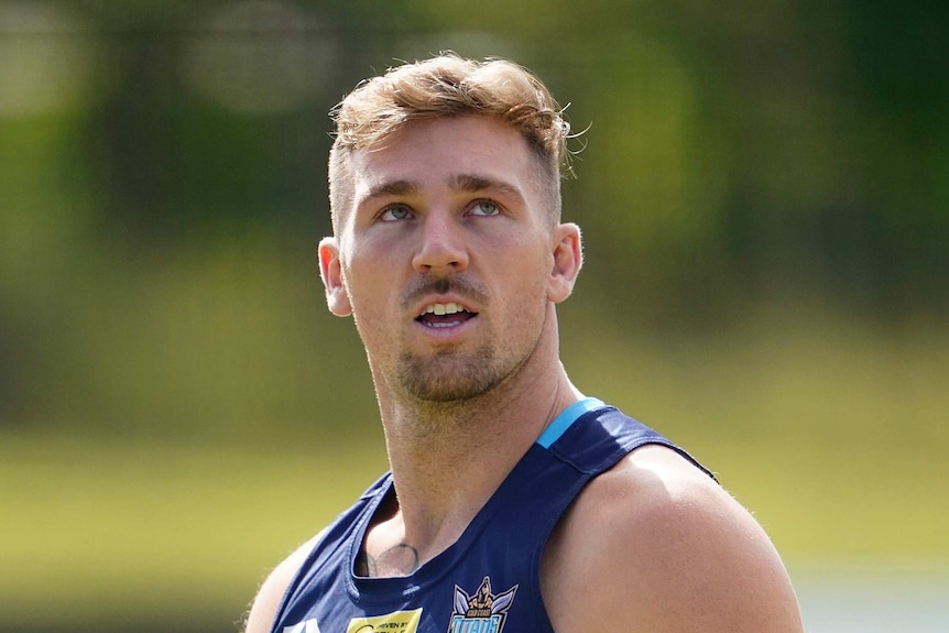 Bryce Cartwright looks up wearing a dark blue singlet