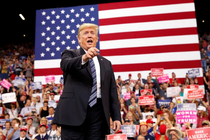 Trump greets the crowd as he arrives at a campaign rally.