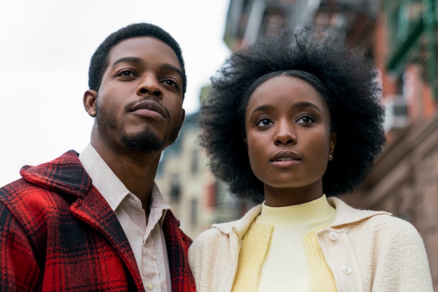 Mid-shot colour still of Stephan James and KiKi Layne looking into distance in 2018 film If Beale Street Could Talk.