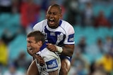 Trent Hodkinson is congratulated by team-mate Ben Barba after kicking the winning field goal.