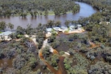 A drone image showing a birdseye view of flooding on roads along a River Murray community