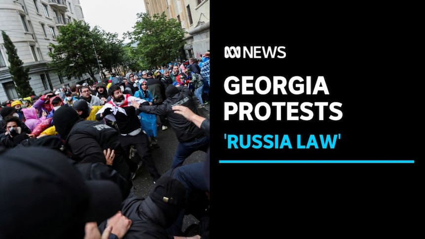 Georgia Protests, 'Russia Law': Protesters clash with police on a city street.