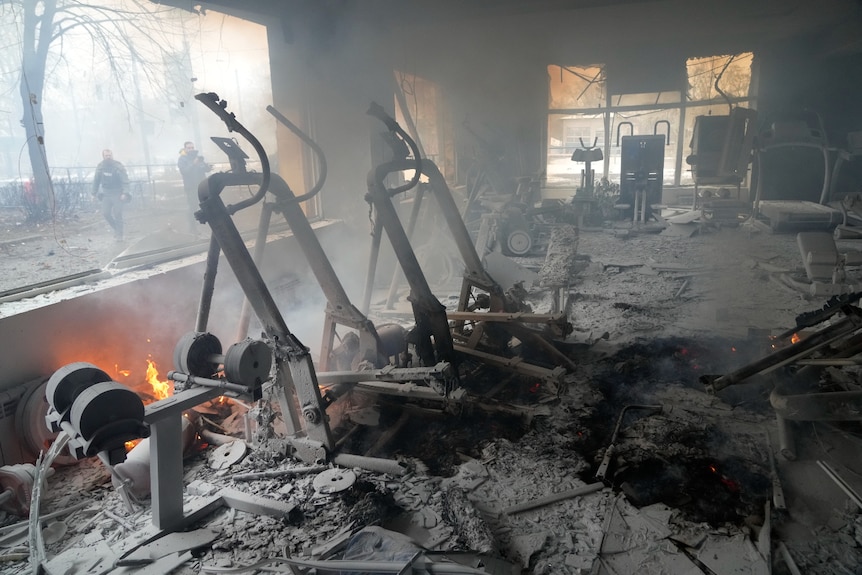 Flames and smoke rise from a damaged gym following shelling in Kyiv.