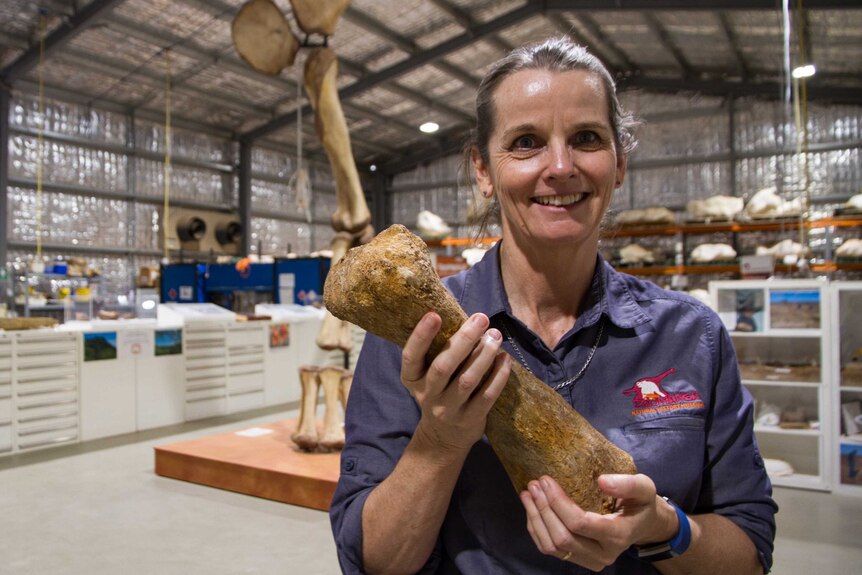 Robyn Mackenzie general manager of the Eromanga Natural History Museum holding a fossil