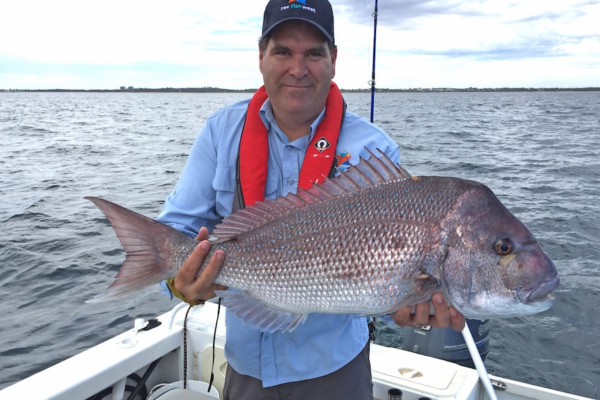 A man holding a fish.