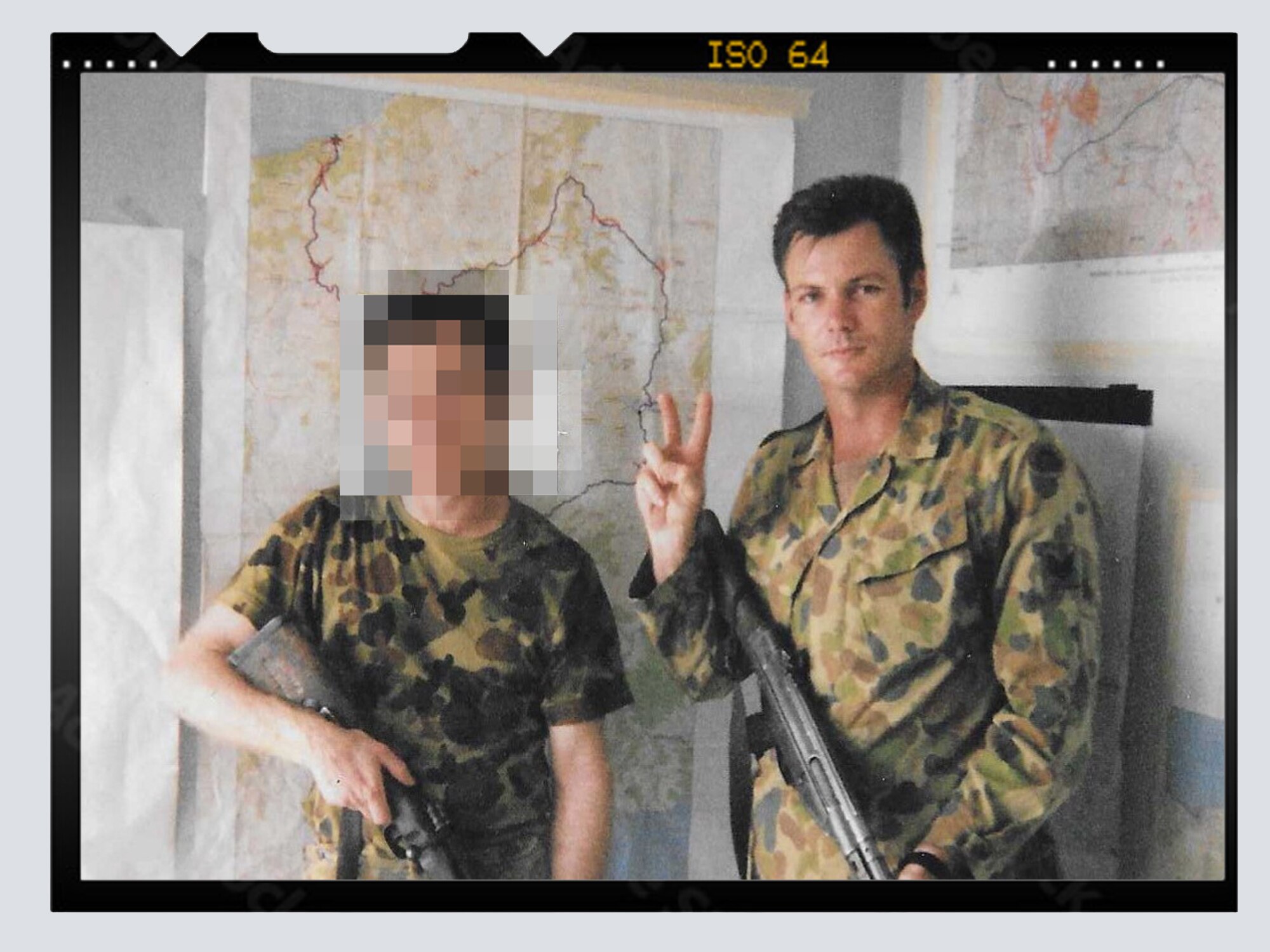 Intelligence sergeant Michael Clarey pictured in East Timor inside with his gun.