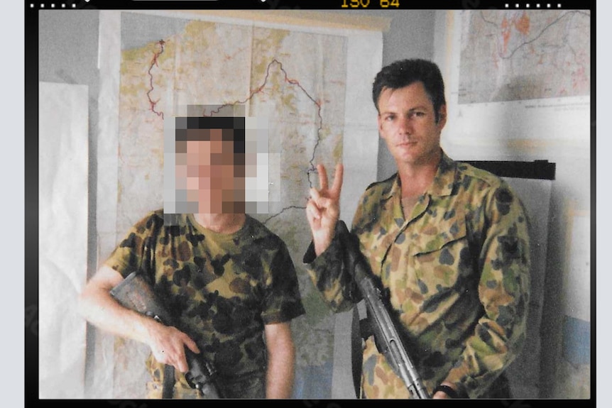 Intelligence sergeant Michael Clarey pictured in East Timor inside with his gun.