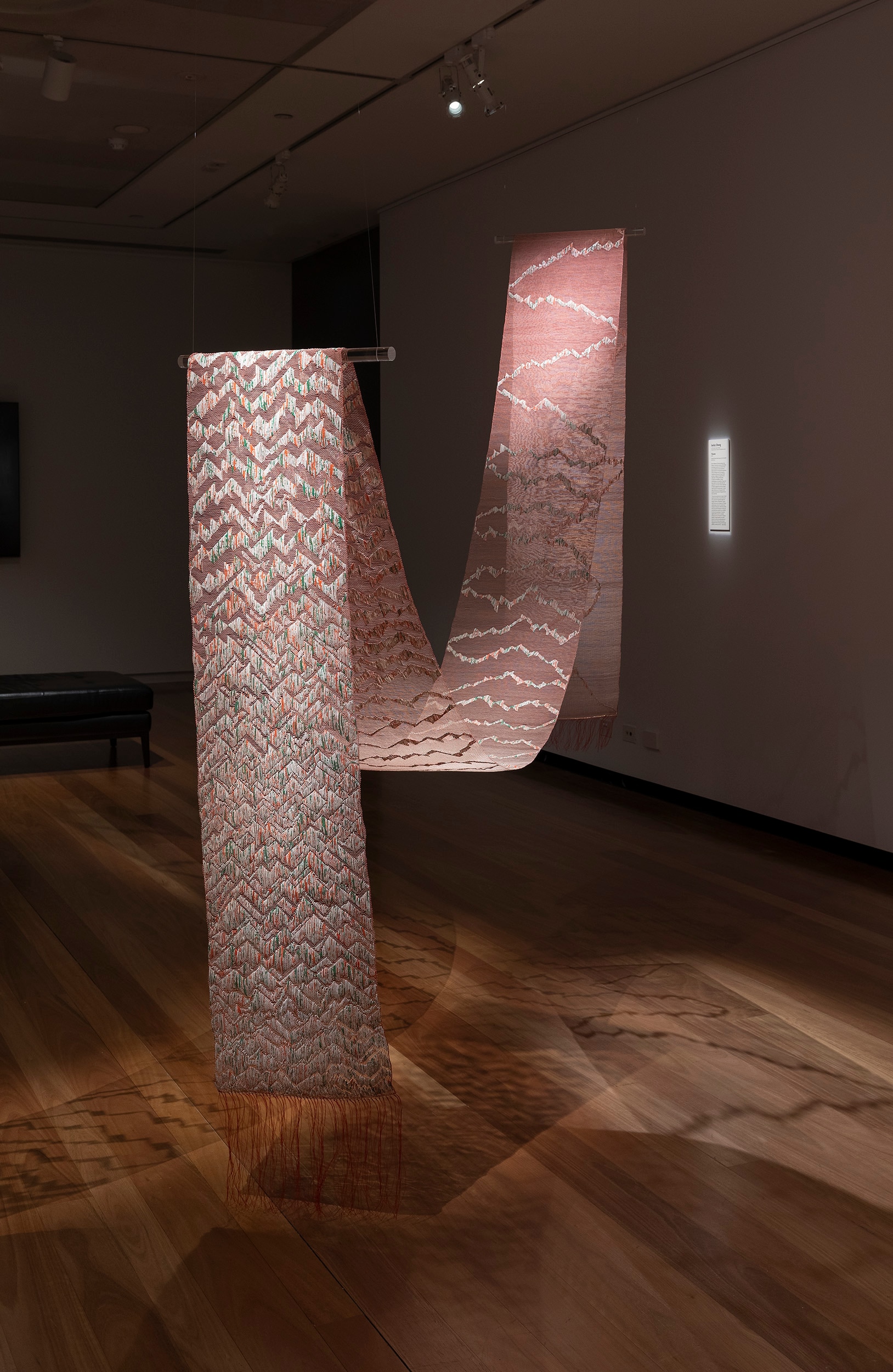 Thrums by Jacky Cheng, featuring a loop of upcycled Chinese calendar papers, Tyvek, nylon thread, kozo paper.