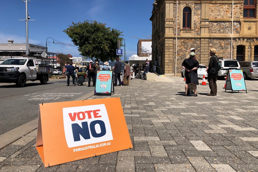 A Vote No placard on a footpath