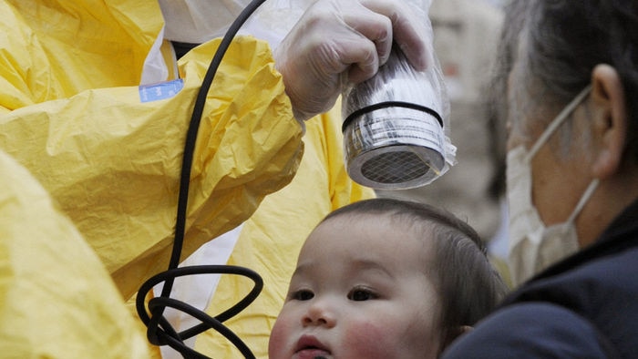 A baby is scanned for radiation in Nihonmatsu