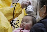 A baby is scanned for radiation in Nihonmatsu, Fukushima Prefecture
