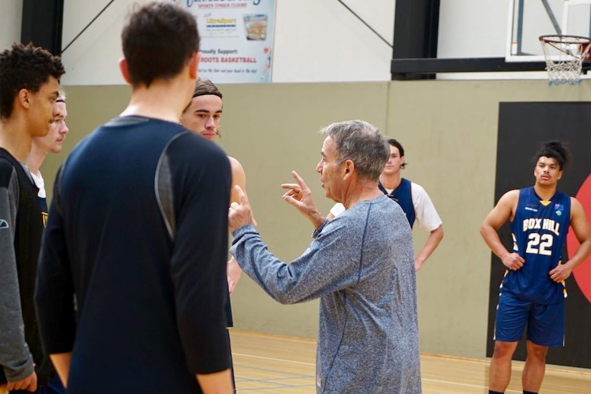 Box Hill Senior College basketball coach Kevin Goorjian talks to his players.