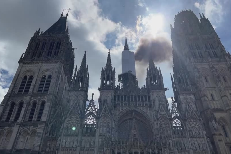 A cathedral with black smoke 