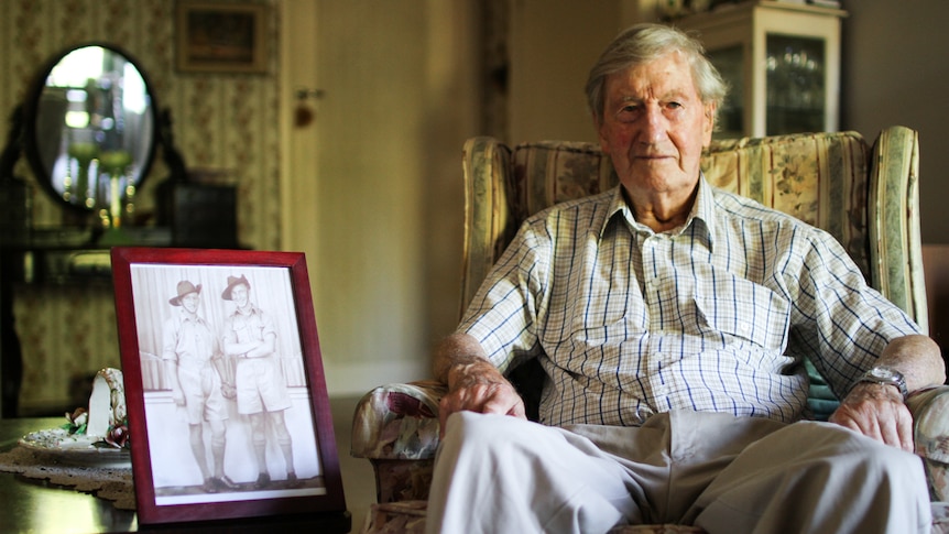 Colin Hamley sitting in an armchair at home in Melbourne