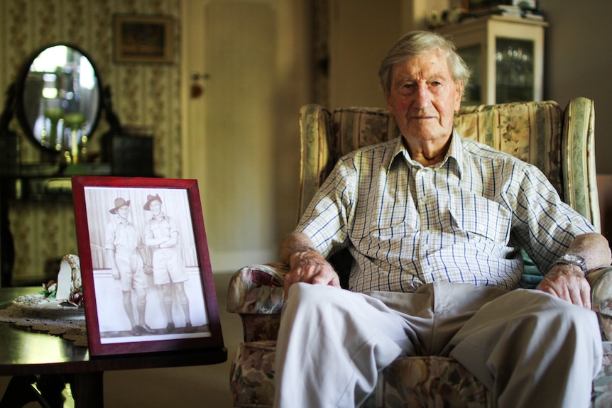 Colin Hamley sitting in an armchair at home in Melbourne