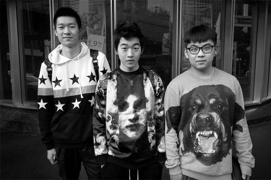 Three men wearing printed jumpers in Sydney.