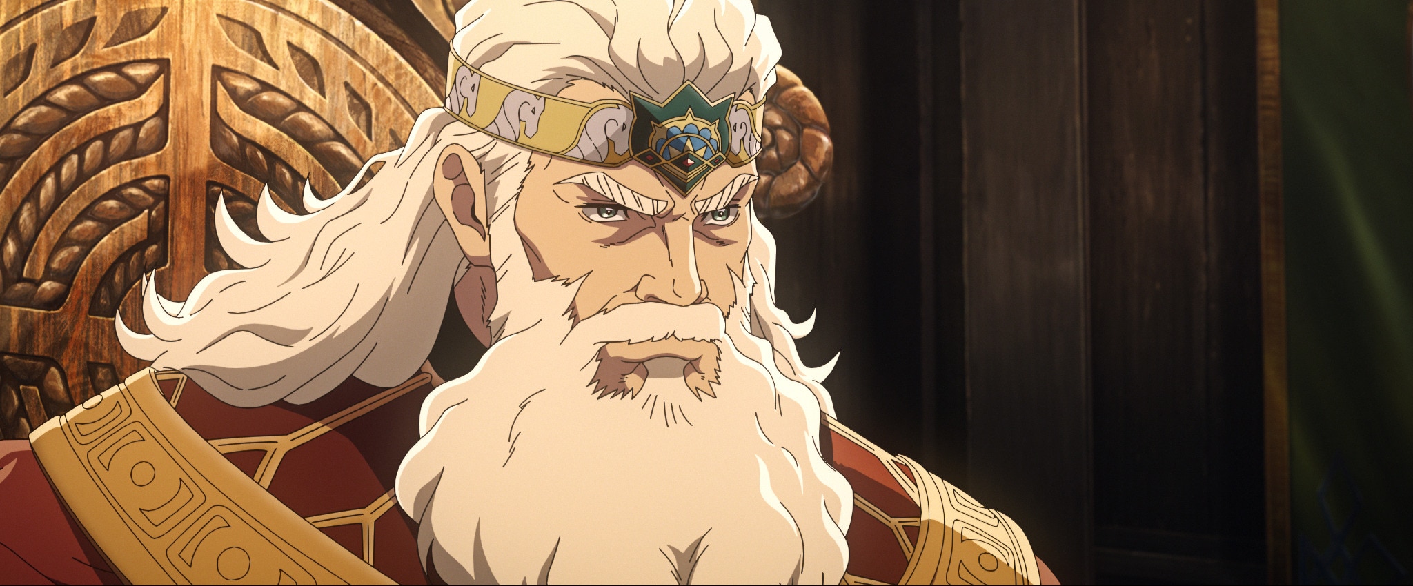 A still from an animated film showing a fierce-looking man with grey flowing hair and beard wearing a gold crown