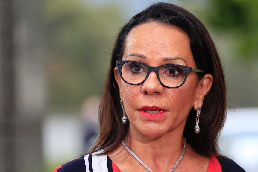 Linda Burney speaks to reporters before Question Time, she is wearing glasses