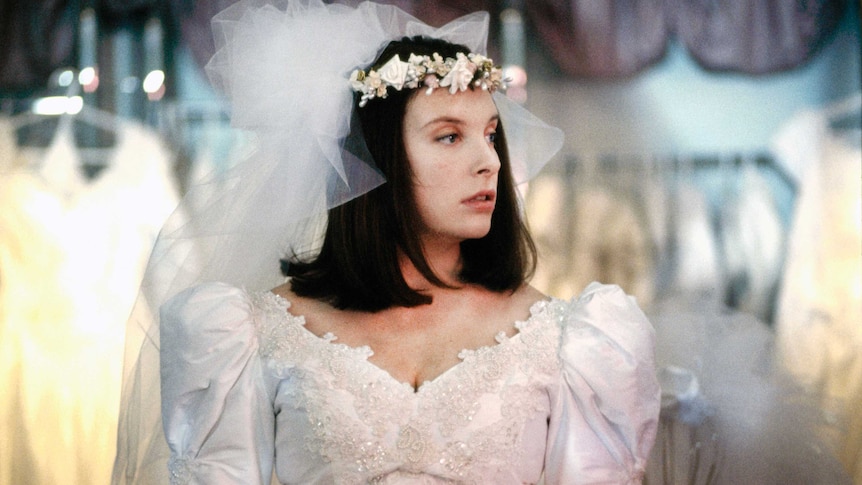 Muriel's Wedding - Toni Collette as Muriel trying on a wedding dress  by Robert McFarlane