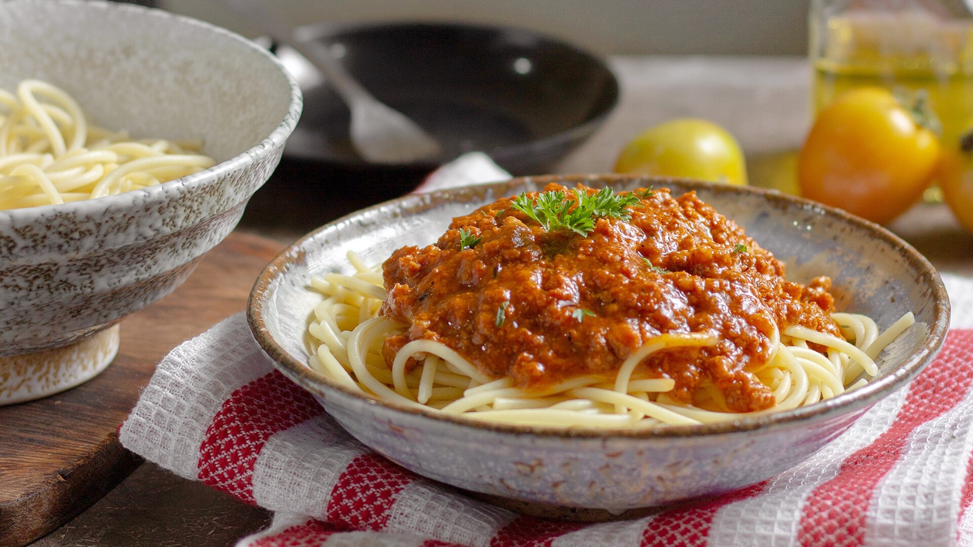 A tasty bowl of spaghetti bolognaise on a kitchen counter.