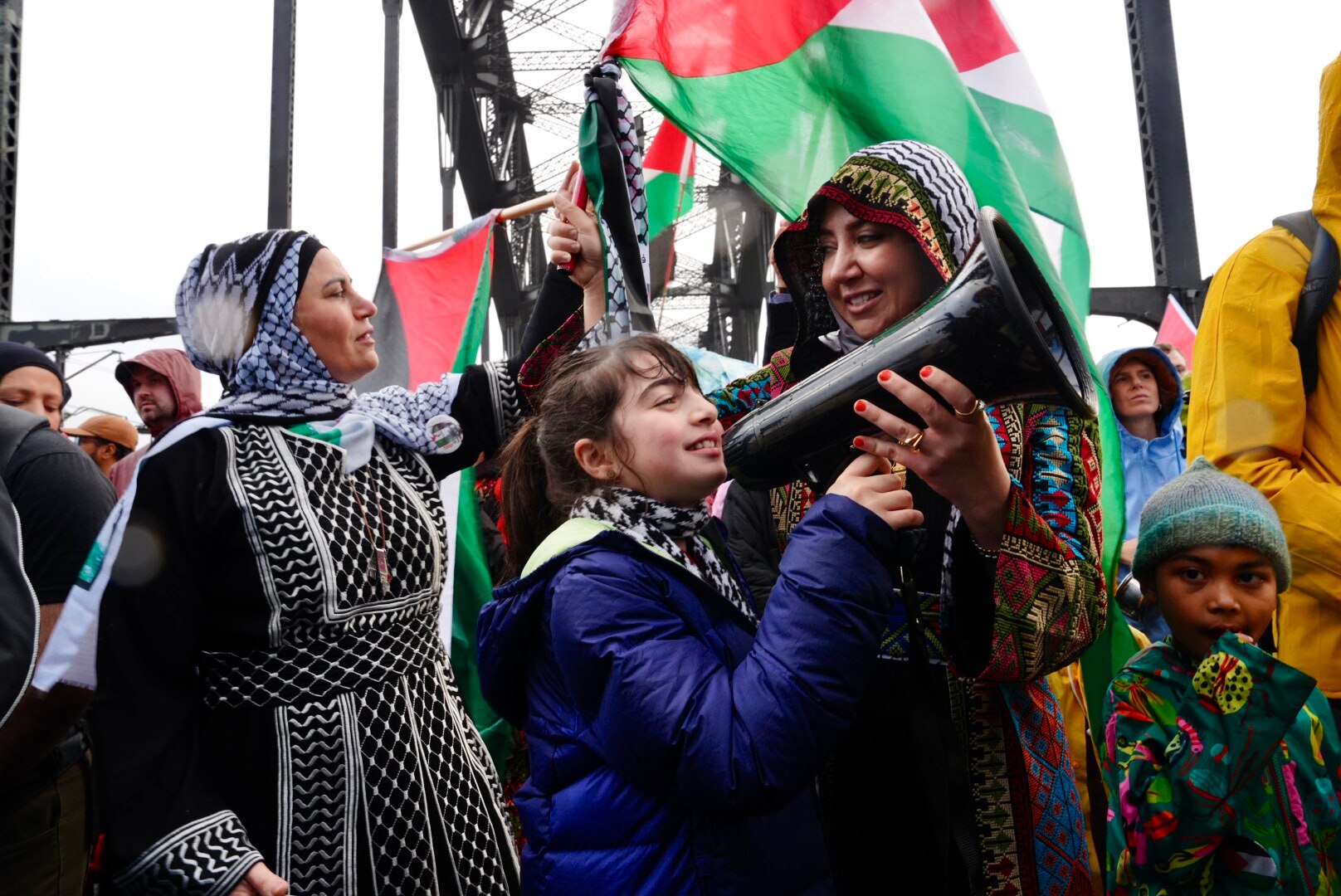 Young girl with megaphone at the pro-palestine rallyh overf the harbour bridge
