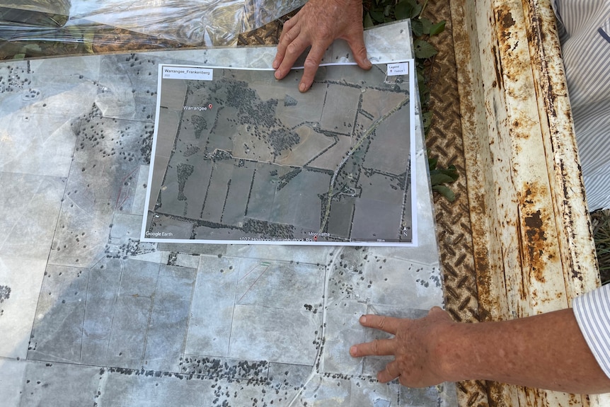 Two maps sit side by side in the tray on a ute 