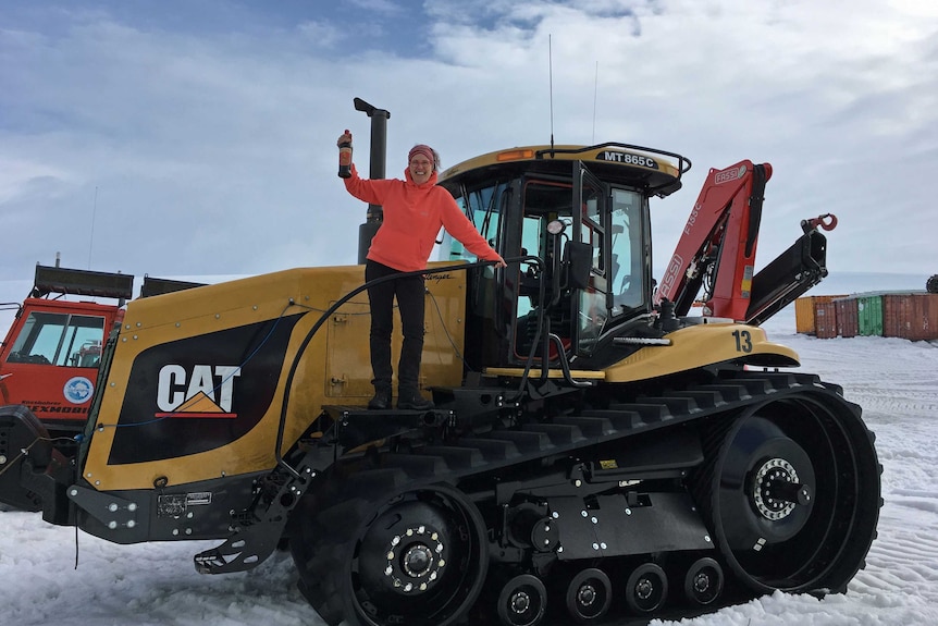 Karen Rees standing on a tractor in Antarctica