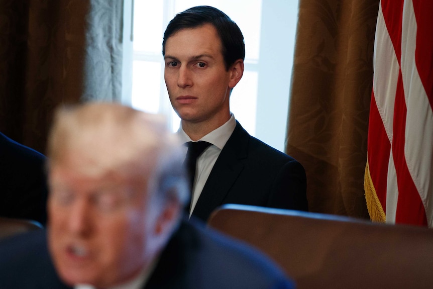 White House senior adviser Jared Kushner stares at Donald Trump from behind him in the White House