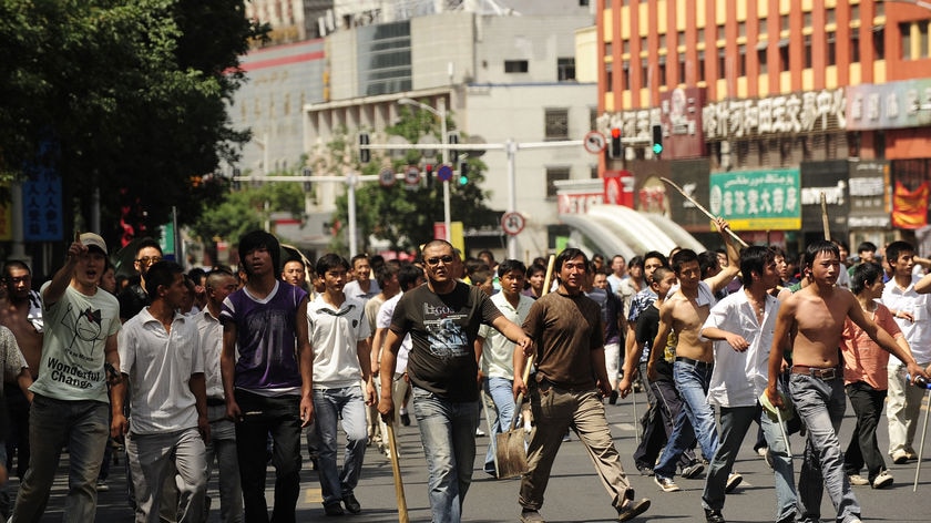 Han Chinese have carried sticks with nails, poles and shovels and marched towards Uighur suburbs.