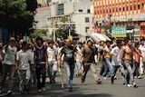 Han Chinese have carried sticks with nails, poles and shovels and marched towards Uighur suburbs.