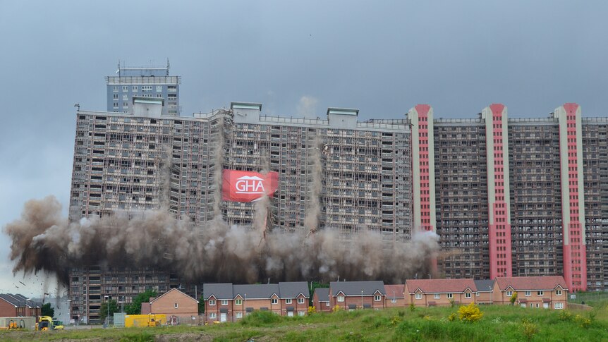 Colour photograph of mid-20th century Red Road Flats in Glasgow being demolished.