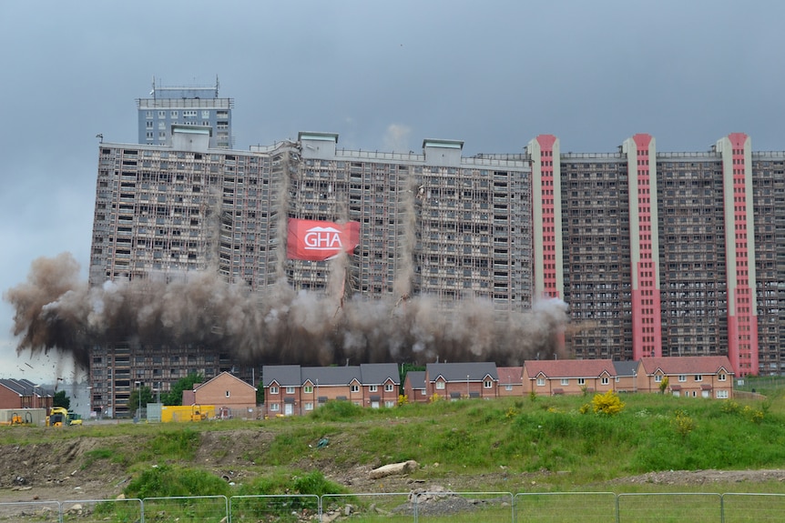 Colour photograph of mid-20th century Red Road Flats in Glasgow being demolished.