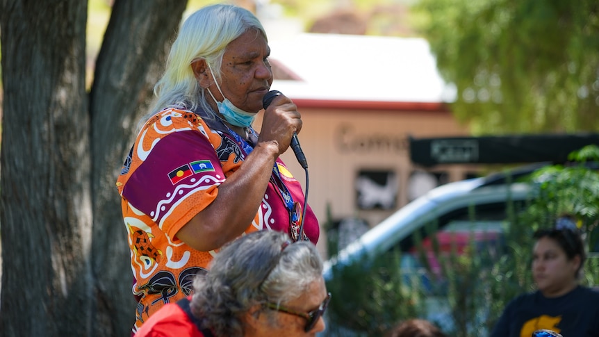 Sabella Kngwaraye Turner speaks into a microphone at an Invasion Day rally in Alice Springs.