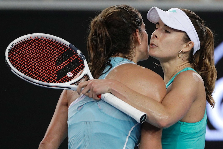 Alize Cornet (R) and Julia Georges embrace at the net following their match at the Australian Open.