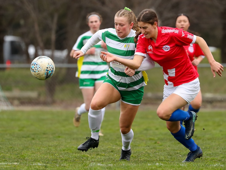 Two female players battle it out for the ball