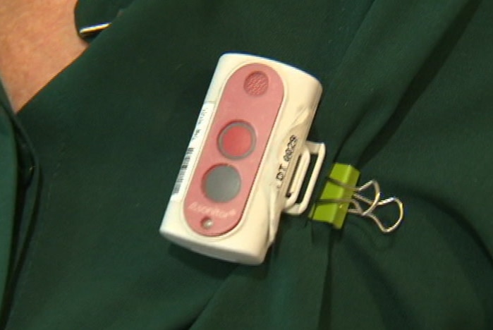 A clip-on device with green and red buttons
